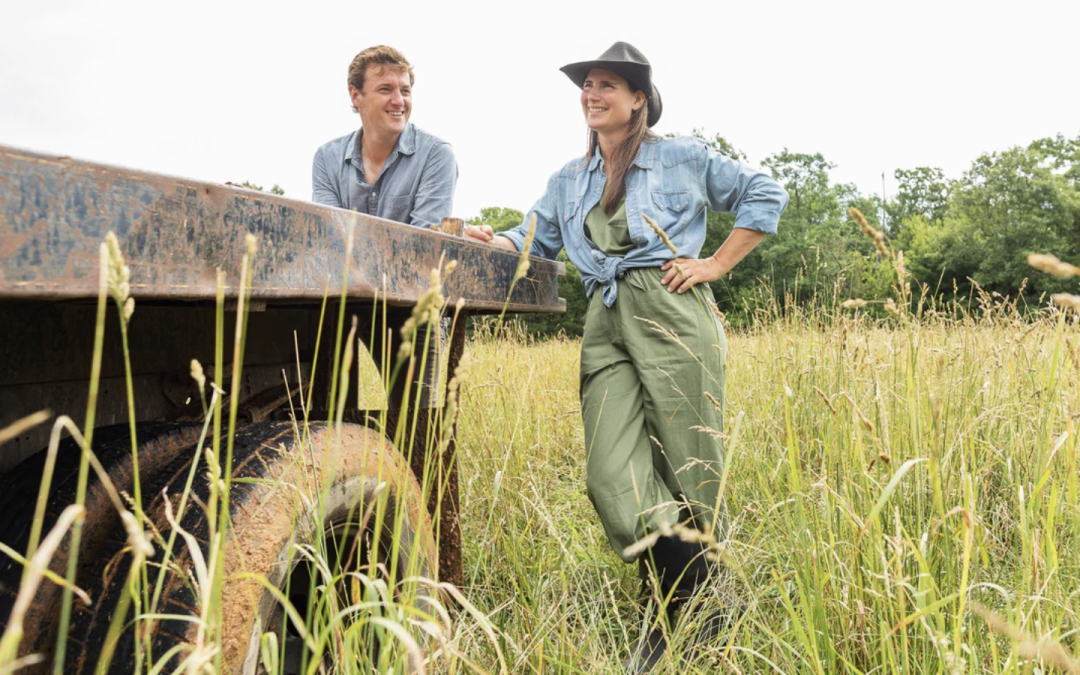 two organic farmers in a field leaning against a truck soil health